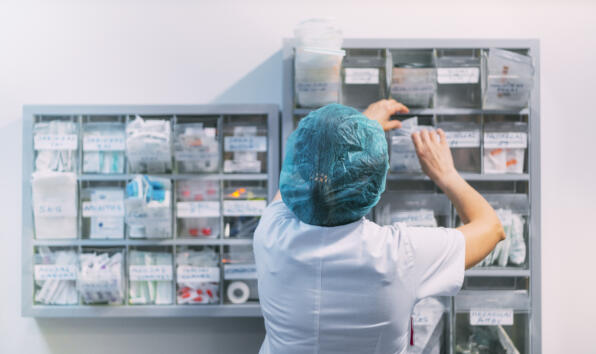 Medical worker searching through medical supplies