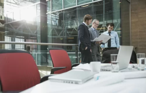 Three businessmen looking at documents