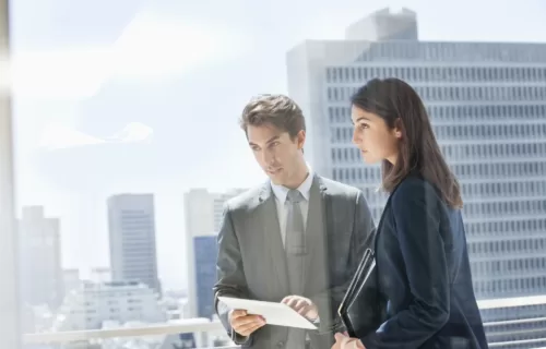 Businessman and businesswoman discussion with tablet in hand